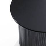 Close-up of a sleek, black round side table with a ridged cylindrical base and smooth tabletop, showcasing its decorative effect that complements any modern style.