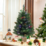 Mini-artifical-christmas-tree-with-red-berries-pinecones-and-glitter-elegant-addition-to-a-coffee-table