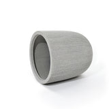 A gray, ribbed, cylindrical concrete planter with a modern striped pattern lies on its side against a white background, perfect for adding a contemporary touch to your home and garden.