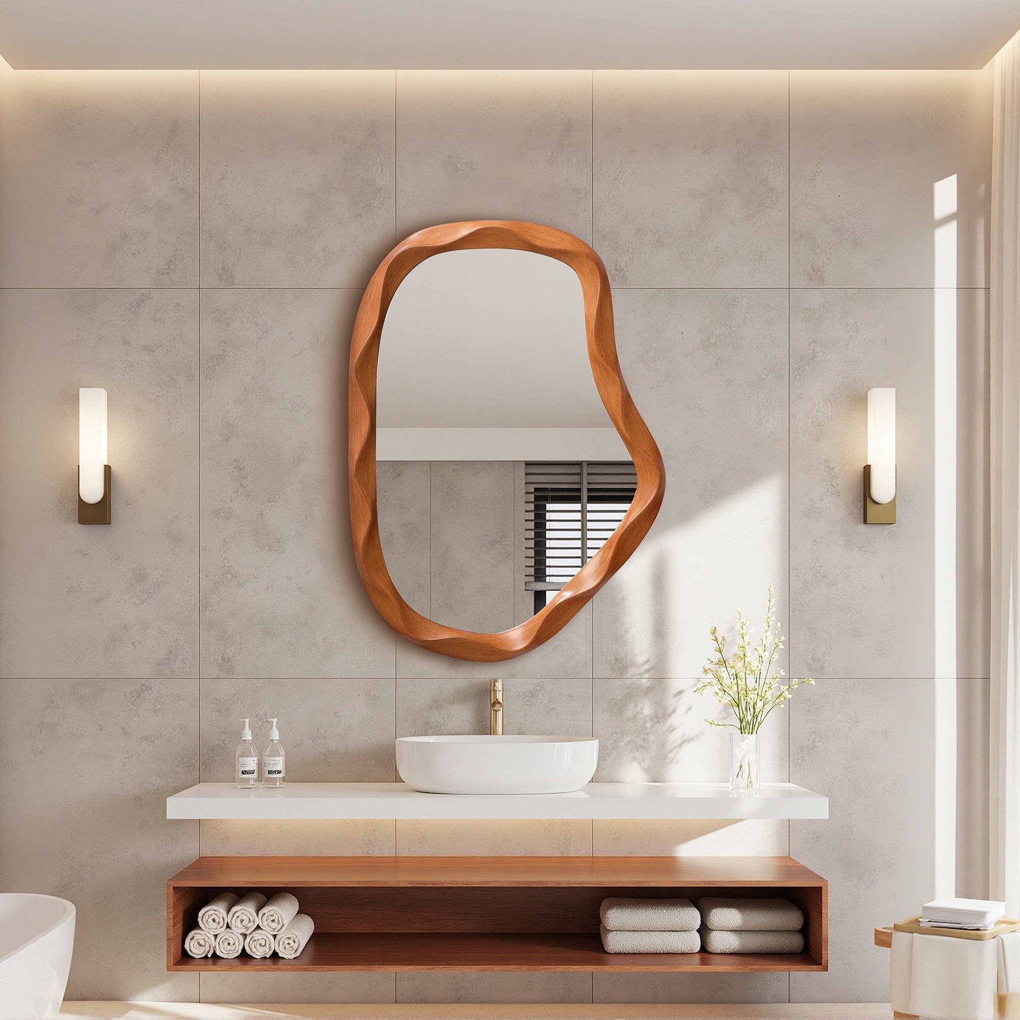 Modern bathroom featuring an asymmetrical wall mirror with a wood frame above a white sink.