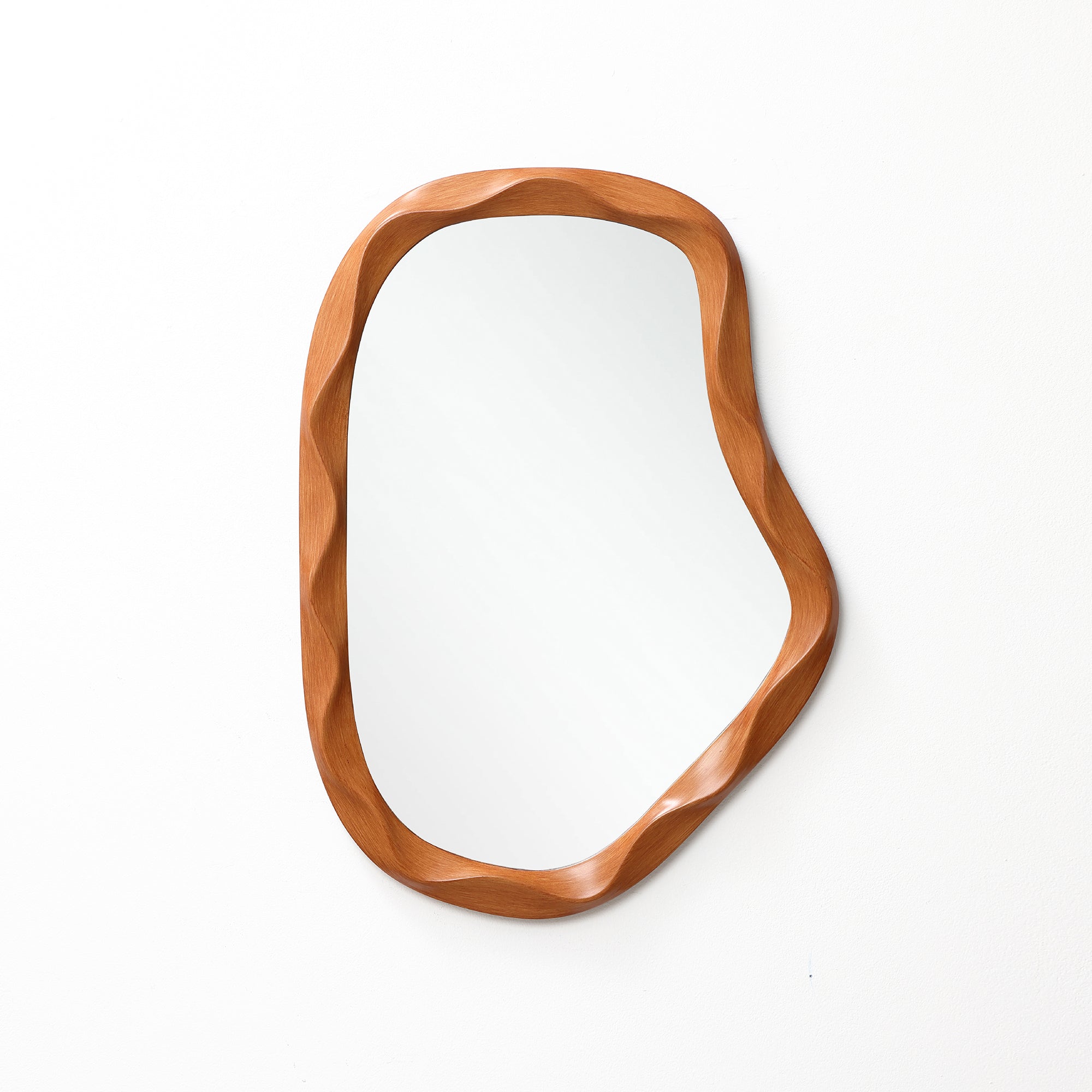 Asymmetrical wall mirror with a wooden wavy-edged frame, perfect as a striking to elevate modern home décor.