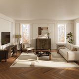 Modern living room with a mid-century walnut sideboard, a large rug, two tall windows letting in natural light.