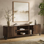 Modern mid-century TV console cabinet sits against a beige wall adorned with framed abstract art.