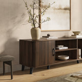 Mid-century modern wooden sideboard sits against a beige wall under framed artwork.