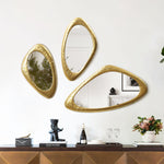 three-gold-framed-mirrors-hanging-on-a-wall