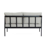 Back view of a modern outdoor loveseat featuring a black steel frame, complemented by light gray cushions.