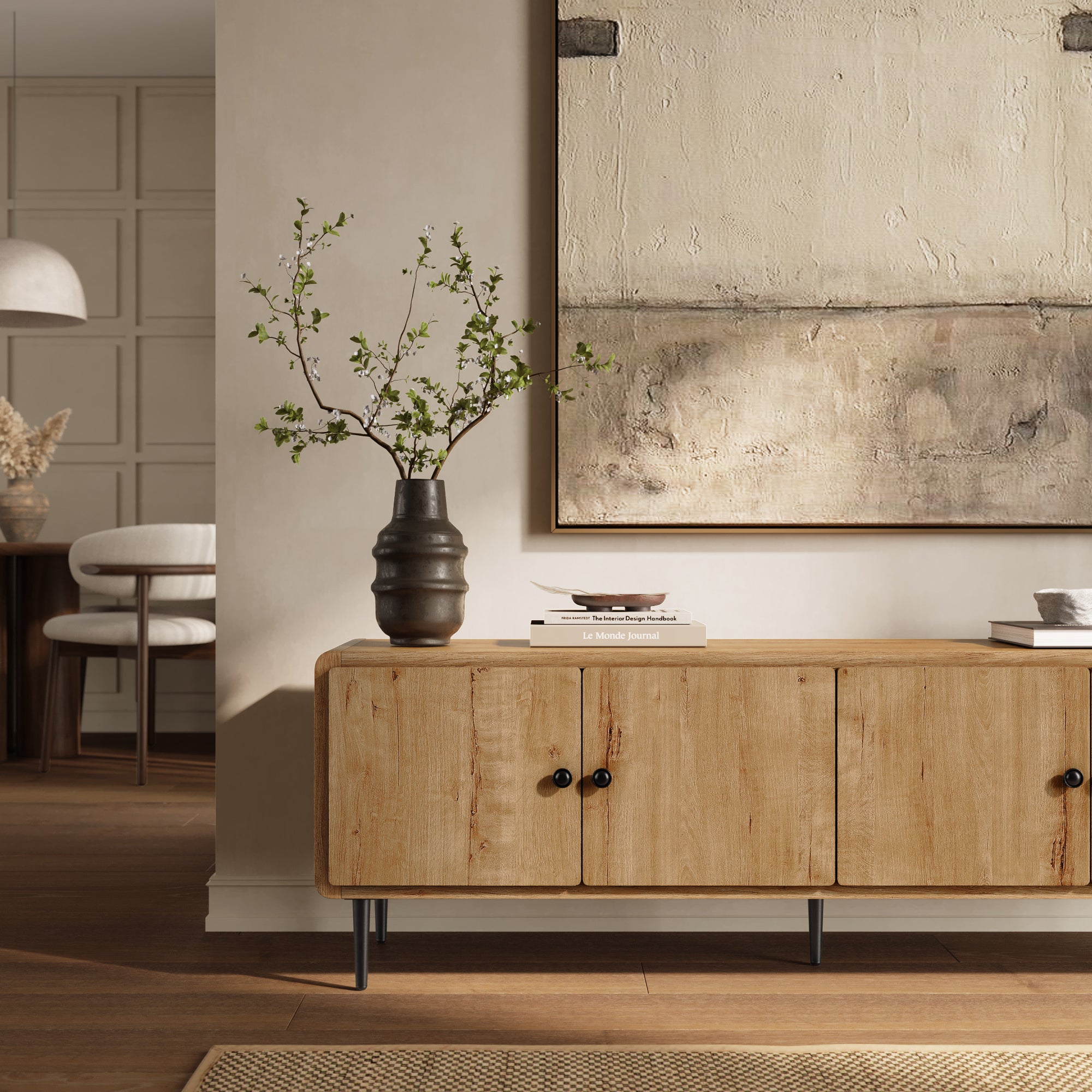 Wooden modern TV stand with doors, a dark vase with branches, books, and a tray on top.