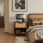End table nightstand on a lamp, framed photos, baskets, and art hanging on the beige wall.