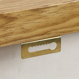 Close-up of a sawtooth picture hanger mounted on the back of a wooden frame, highlighting its role in supporting high-end art pieces as part of modern wall decor.