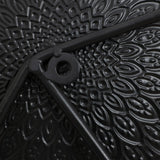 This abstract metal wall decoration showcases a close-up of a black, textured surface with a circular hole and intersecting rods. The pattern, resembling petals radiating outward, adds an artistic touch perfect for enhancing your home decor.