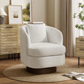 white janice upholstered swivel accent chair with dark wood accent base by the side of a white fluted end table