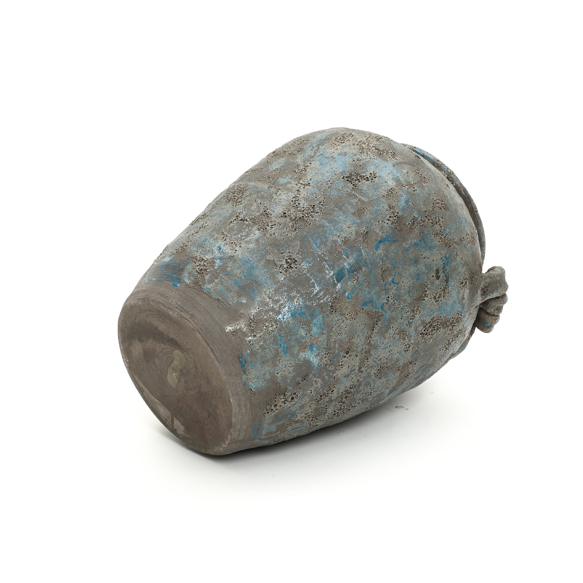 Weathered terracotta vase with a blue-gray mottled surface lies on its side against a plain white background.