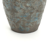 Close-up view of the lower half of a textured, gray and blue ceramic vase, an ideal accent for vintage home decor.
