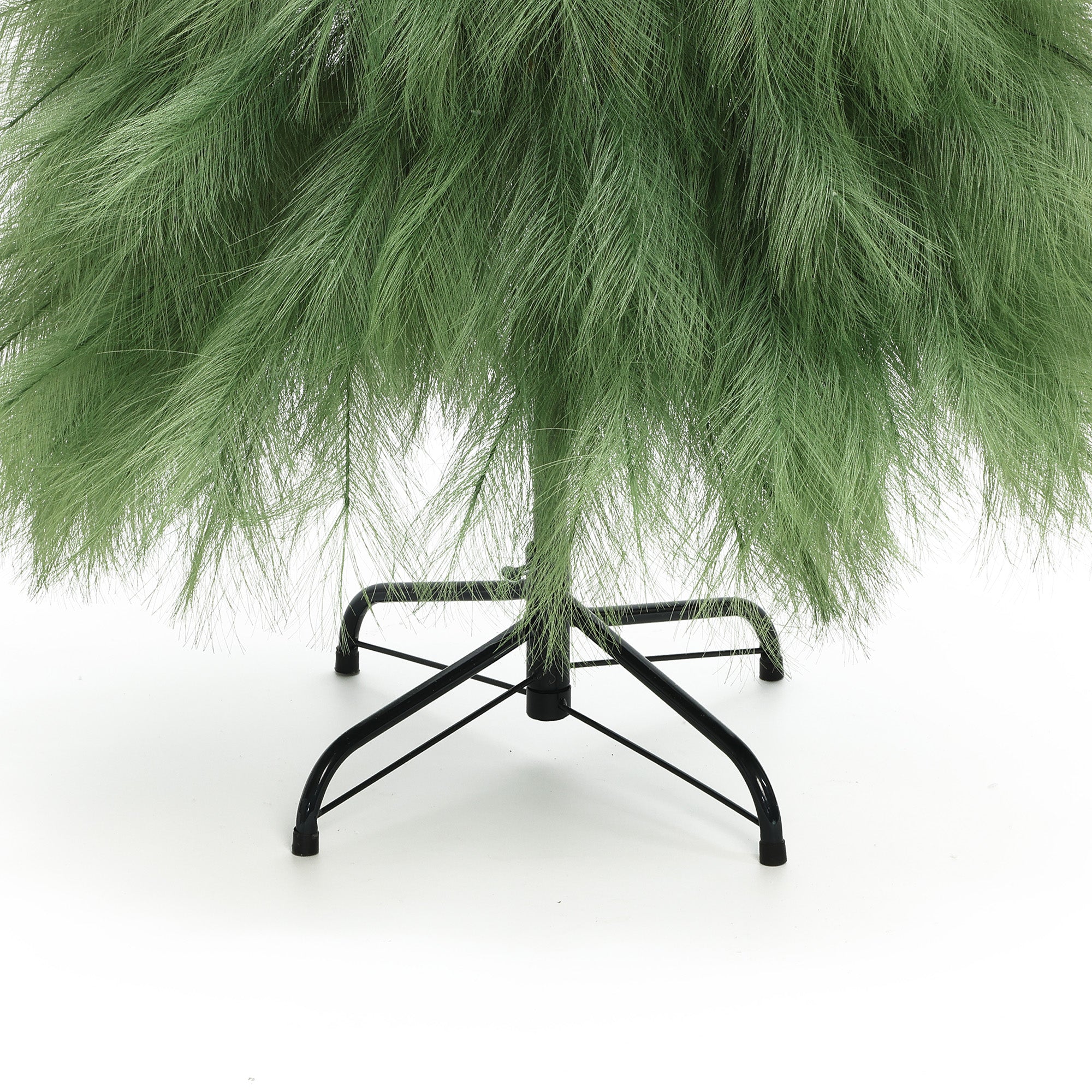 5ft artificial tree with feathery branches, supported by black metal stand on white background.