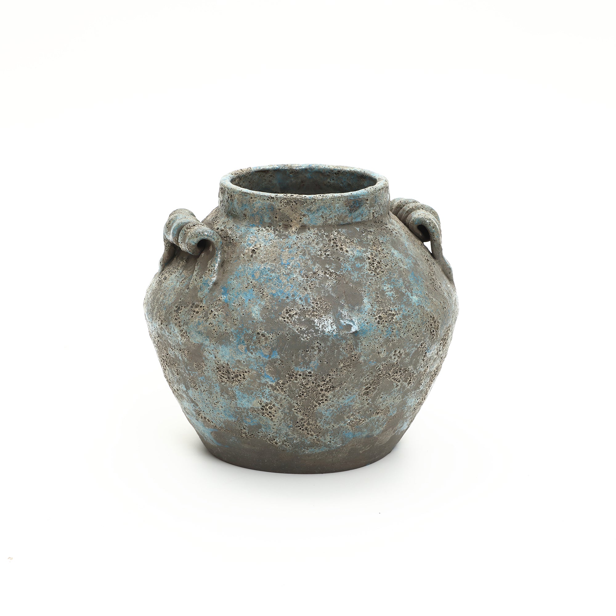 A round weathered terracotta vase with a blue-green patina, two handles on each side, and a wide opening.