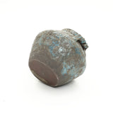 Weathered round handcrafted vase with a blue and brown textured surface, shown against a white background.