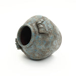 Textured round ceramic vase with a rough blue and gray surface, featuring two small decorative handles.