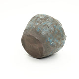 Weathered round-bottomed handcrafted pottery vessel with a mottled brown and blue surface.