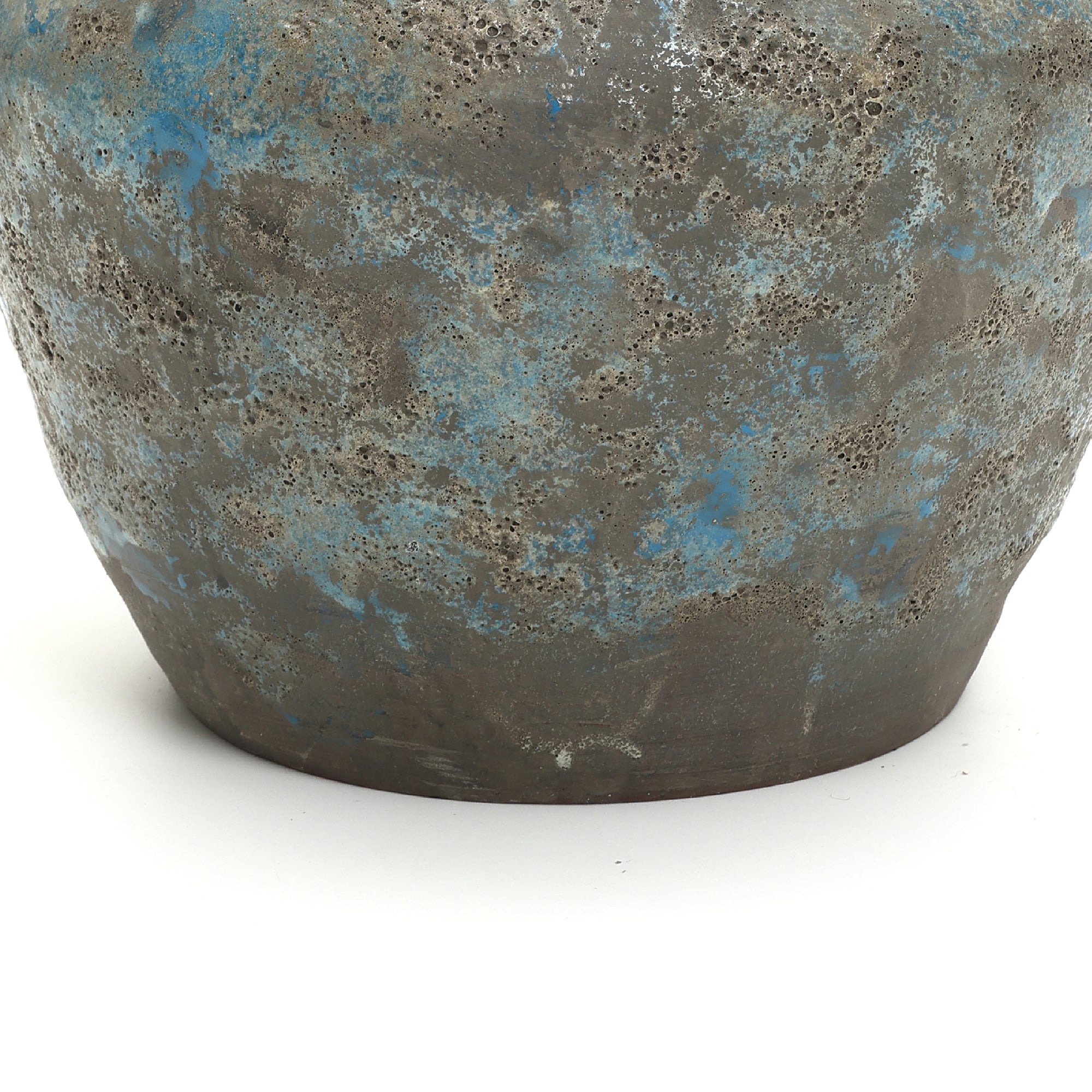 Close-up of a round ceramic vase with a mottled gray and blue surface, showcasing handcrafted pottery.