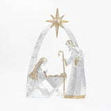 Silver ,gold nativity scene decor featuring Mary, Joseph holding a staff, baby Jesus in a manger under star.
