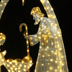 Outdoor holiday decor nativity scene features illuminated depicting a figure withstaff beside a manger.