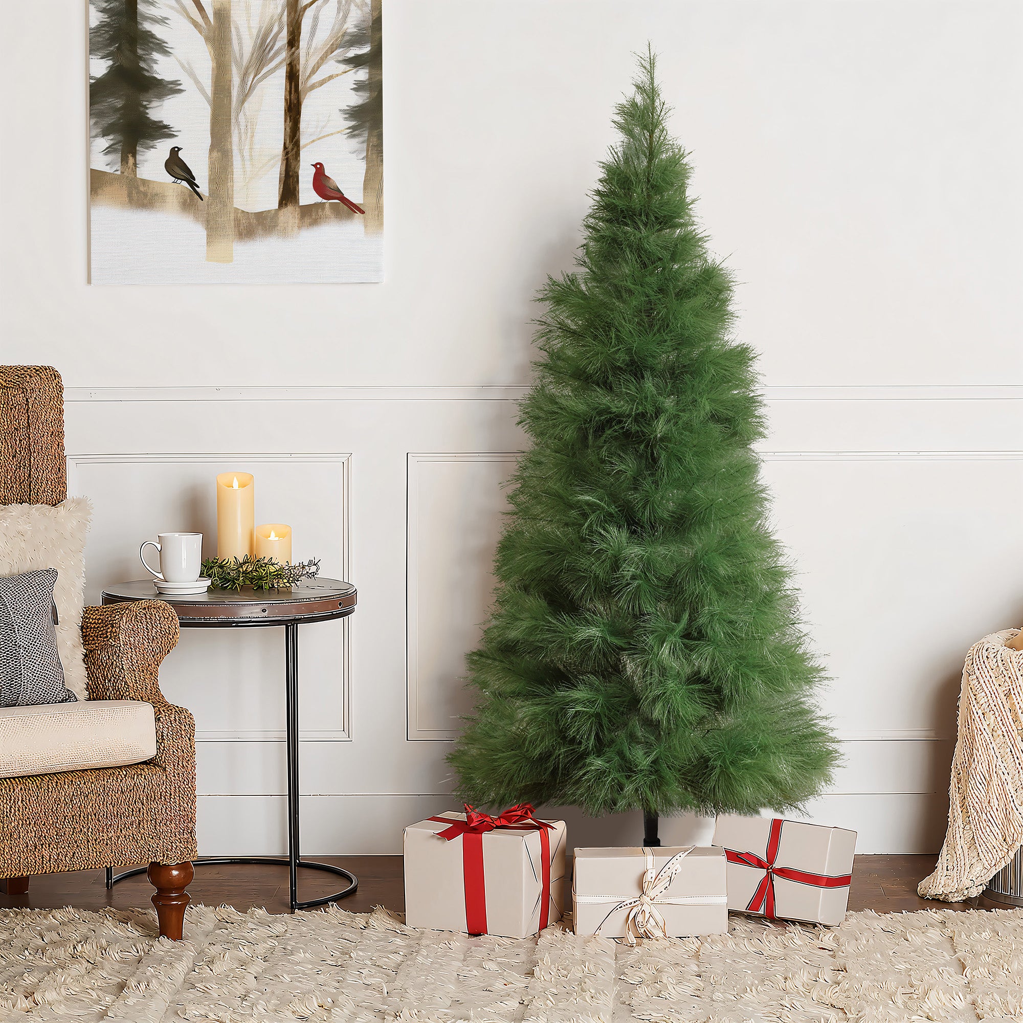 Green artificial christmas tree with 3 wrapped gifts underneath, next to cozy chair, table with candles.