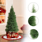 Artificial christmas tree with fluffy green branches stands on tree skirt, wrapped gifts, close-ups of the branches are shown on the right.