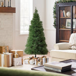 Small pampas grass tree stands in living room, wrapped presents on the floor, snowy scene visible through the window.