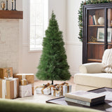Small pampas grass tree stands in living room, wrapped presents on the floor, snowy scene visible through the window.