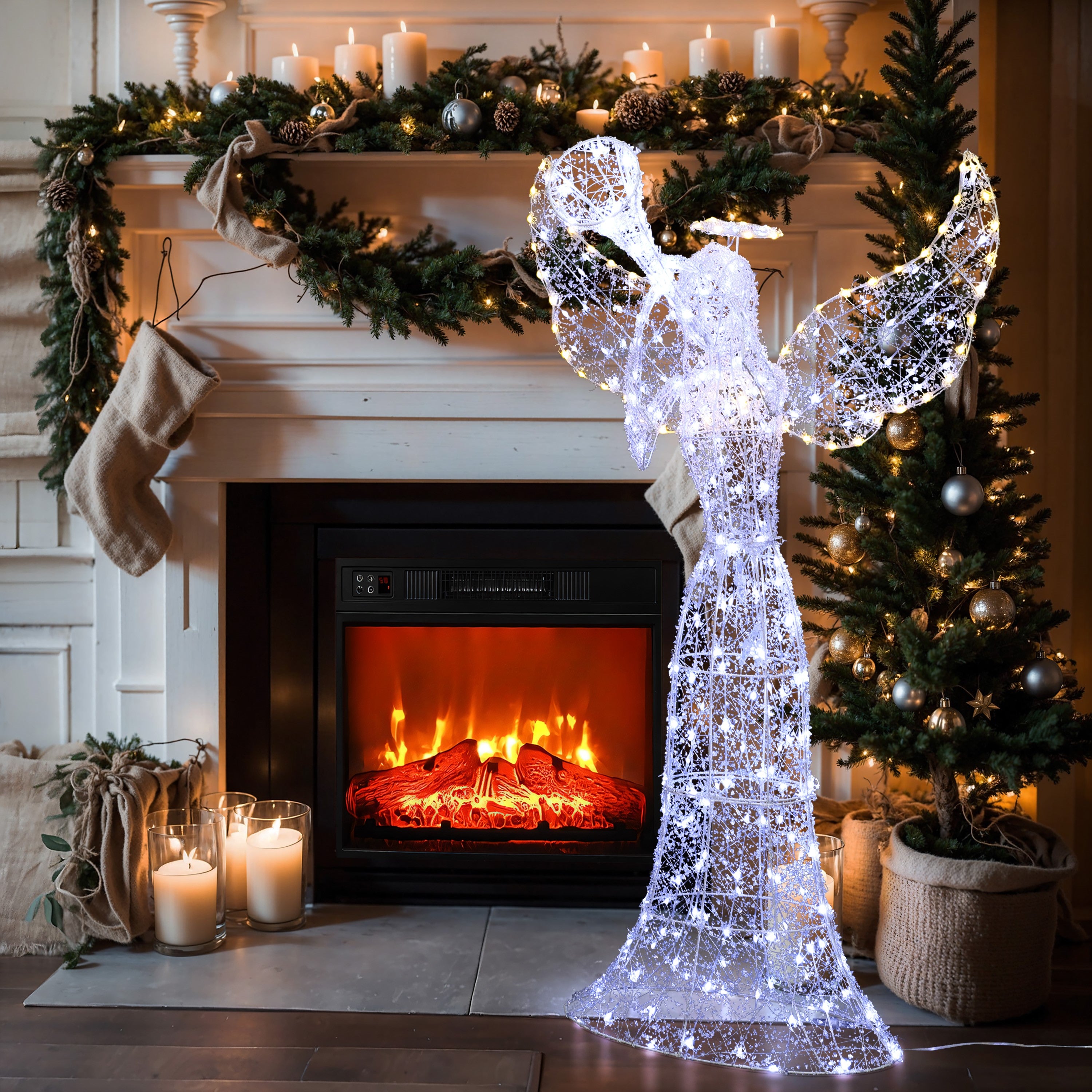 Wire frame angel decor with white lights stands in front of a fireplace with candles, stockings, garland.