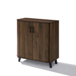 Dark sideboard cabinet with two doors, black handles, tapered black legs offers stylish storage.