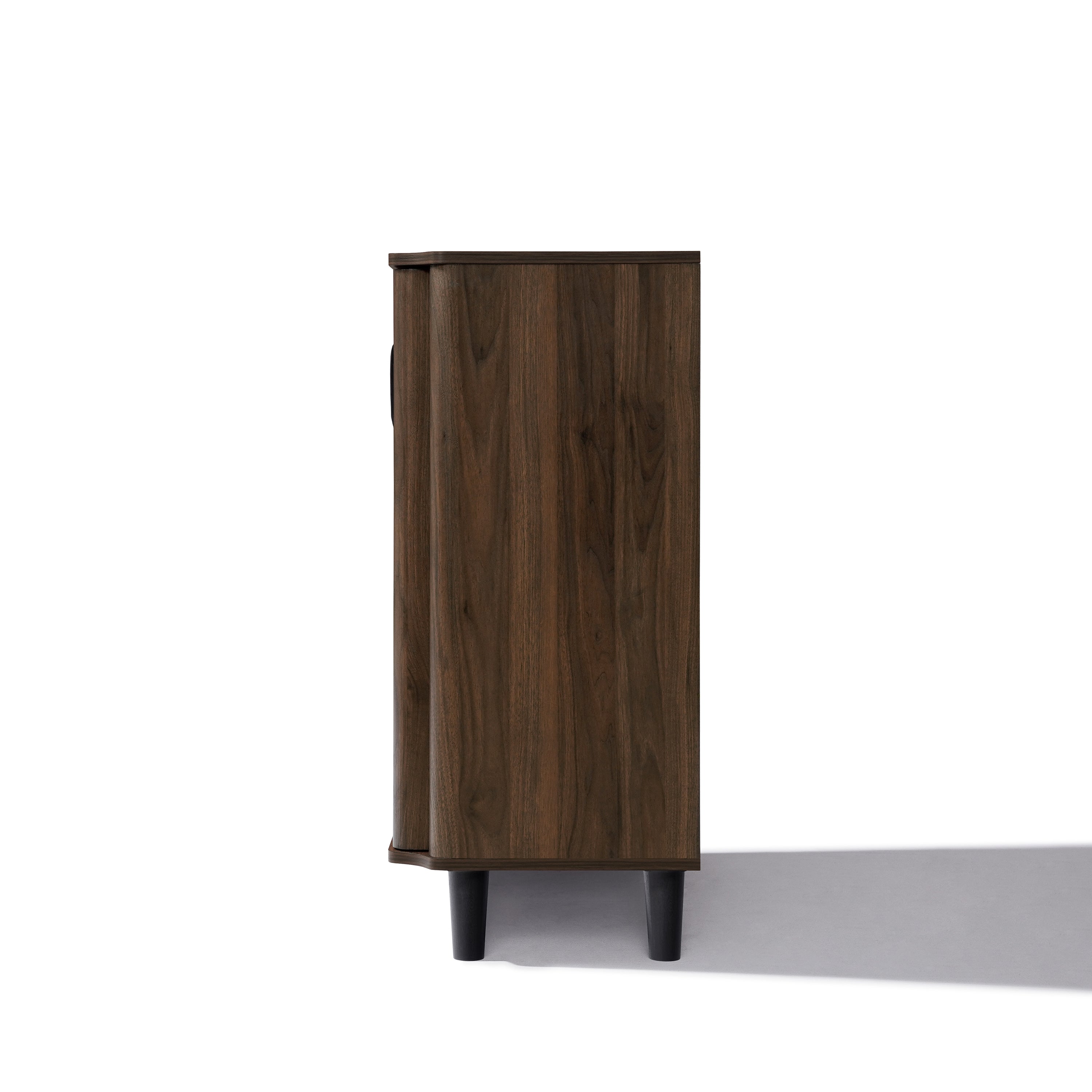 Side view of a mid-century walnut wood sideboard cabinet with four black legs.