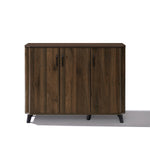 Mid-century walnut wood sideboard cabinet with three doors, black handles, four short black legs.