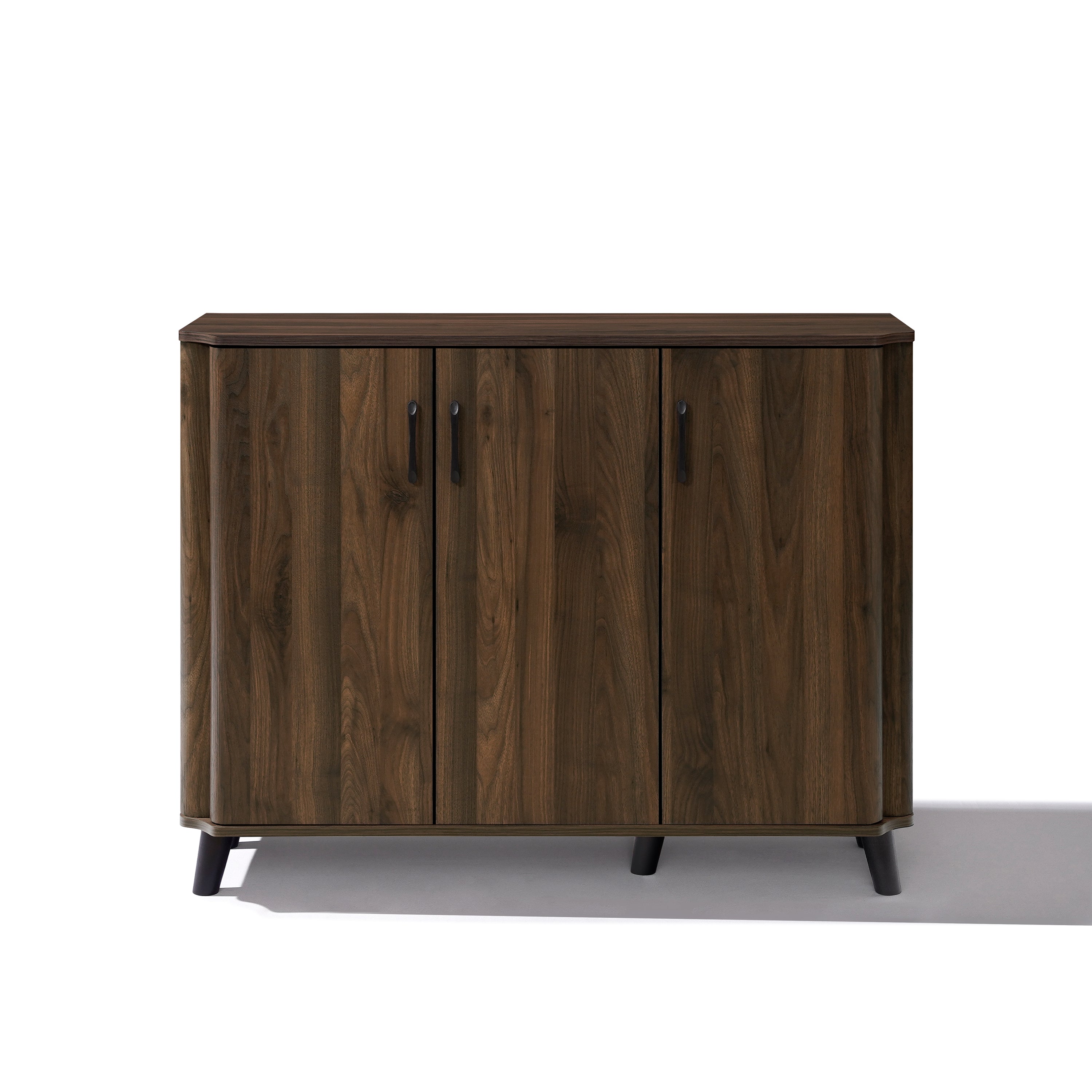 Mid-century walnut wood sideboard cabinet with three doors, black handles, four short black legs.