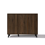 A mid-century walnut storage cabinet with two sliding doors and short black legs.