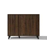 A mid-century walnut storage cabinet with two sliding doors and short black legs.