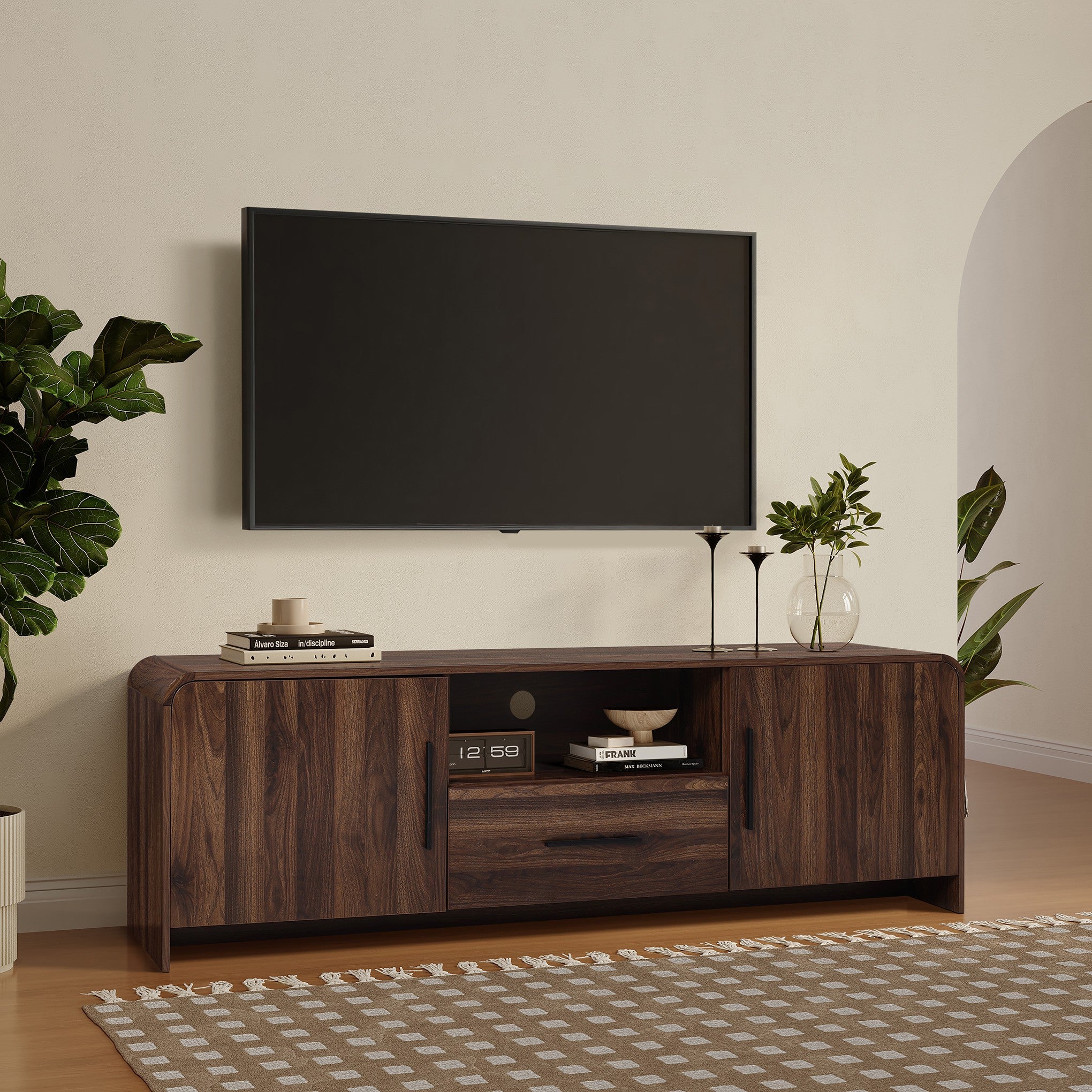 A wood TV console tables stand with books decor items.