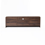 A wood TV console tables featuring a central circular hole for cable management.