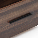 Close up of a dark wood drawer with a black horizontal handle, part of a sleek walnut TV stand entertainment console.