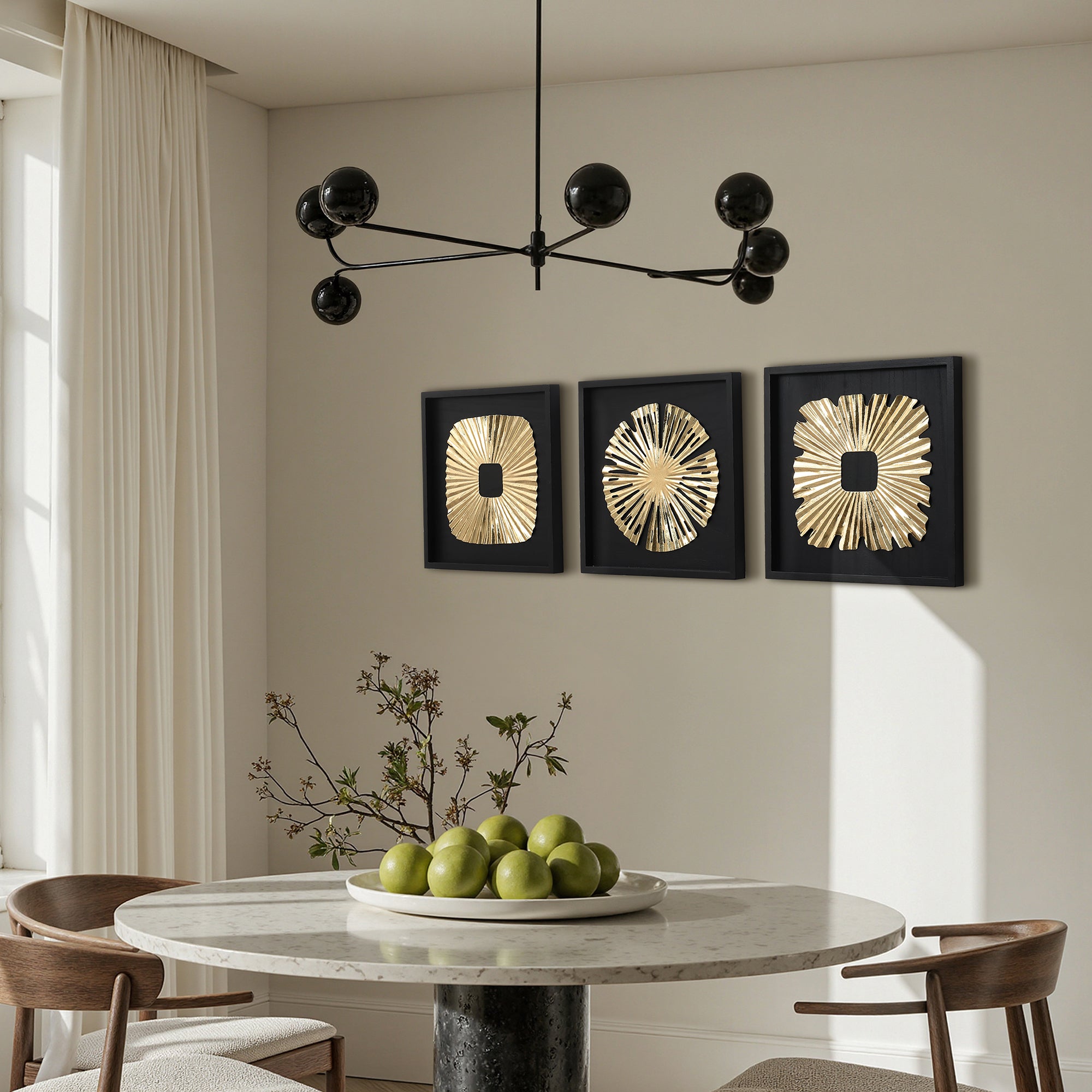 Sits under a black chandelier and three gold abstract metal wall art pieces, creating striking modern wall decor.