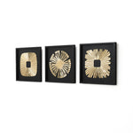 Three square black frames each display a gold abstract sunburst wall art design with different center shapes.