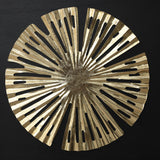 Circular metallic gold decorative object with radial cutouts and irregular edges.