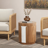 Round wood side table with elegance stands between two armchairs, holding a brown vase with flowers and a closed book.
