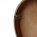 wood storage side table, showing a small rectangular block attached with a dark circular pad.