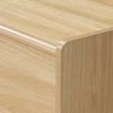 Close-up of a wooden TV console cabinet with smooth, rounded edges and a visible wood grain pattern.
