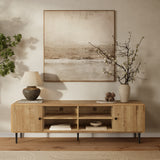 Wooden sideboard offers stylish storage for decor items, all set beneath a large painting on a neutral-toned wall.