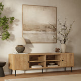 Wooden sideboard serves as a stylish storage piece with open shelves and decor items below a large abstract painting.