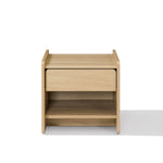 A light oak wood nightstand with a single drawer and an open lower shelf, Scandinavian-Japanese nightstand.