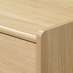 Close-up view of a scandinavian-japanese nightstand with smooth, rounded edges and a simple.