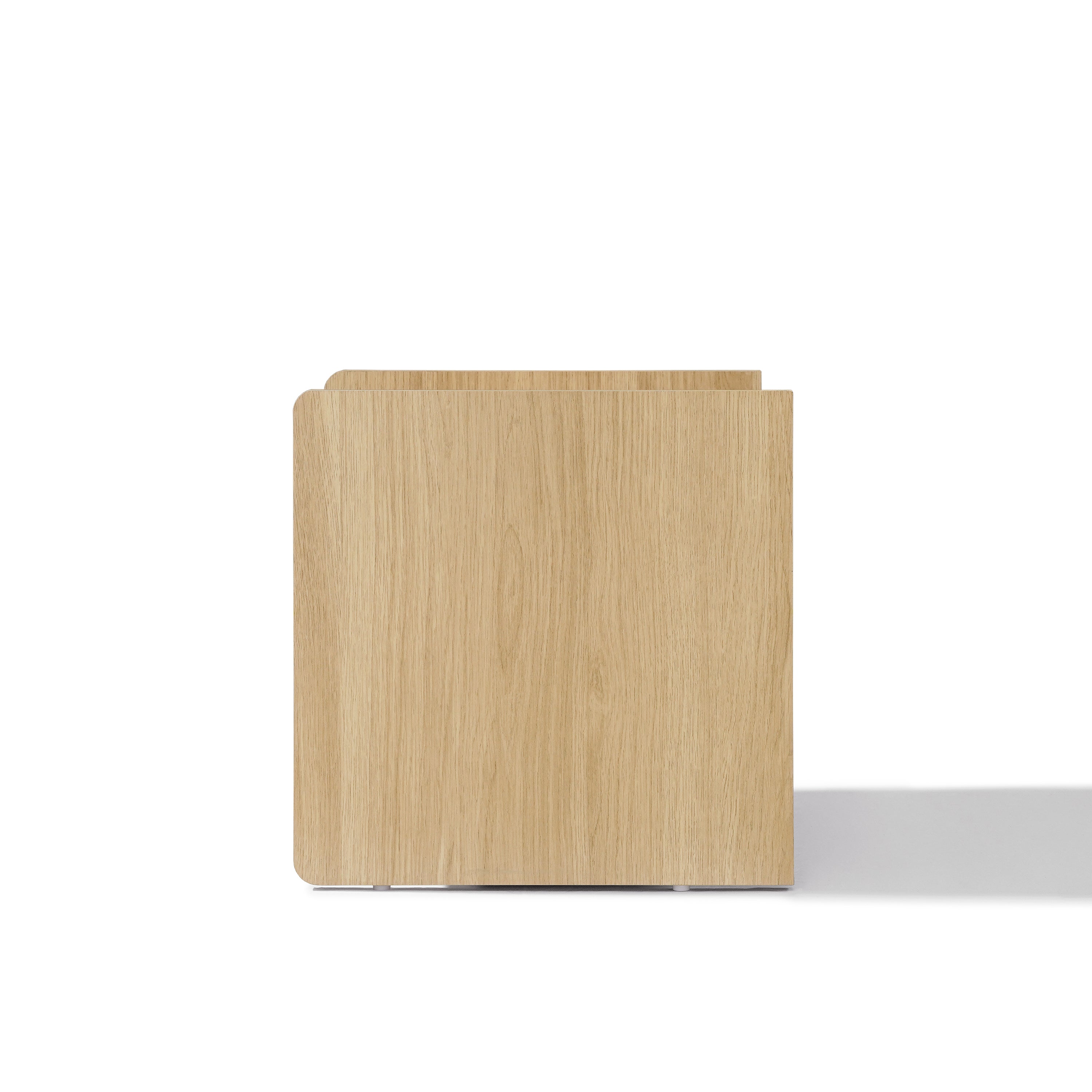 Square light oak wood nightstand with smooth surfaces and rounded corners.